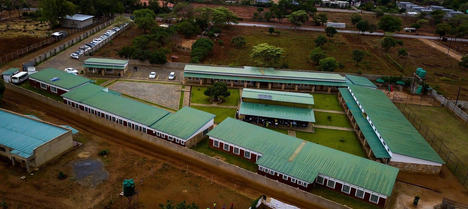Aerial view of the LCMMS campus with its green-roofed classroom blocks