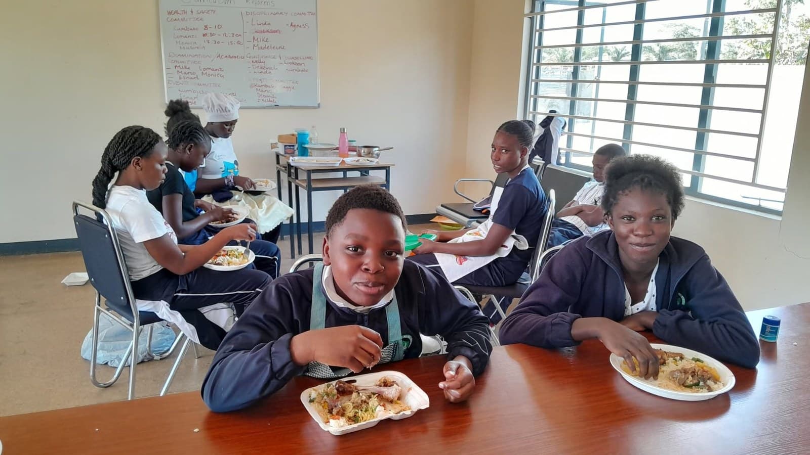 Learners sit with their plated meals following the practical cooking activity
