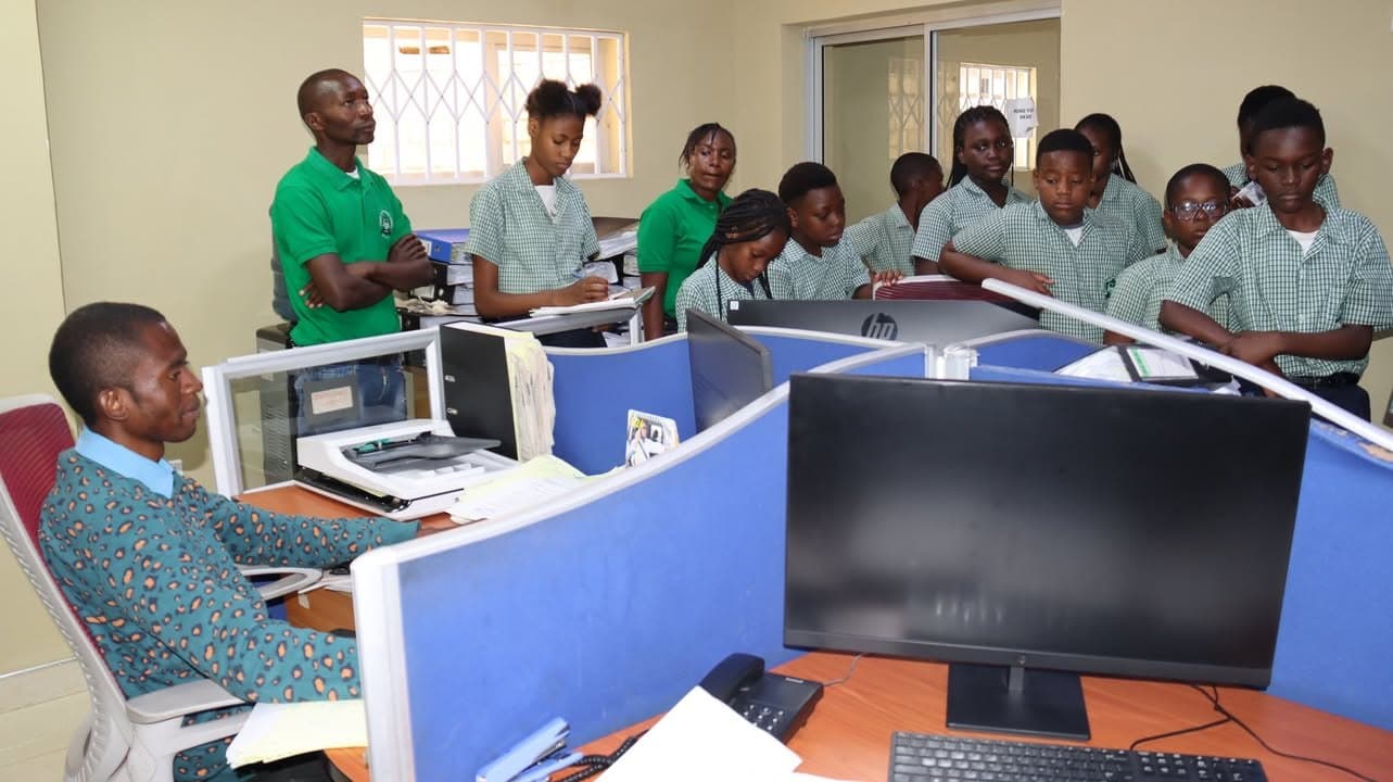 Learners gather around newsroom desks and computer screens during the Zambia Daily Mail visit
