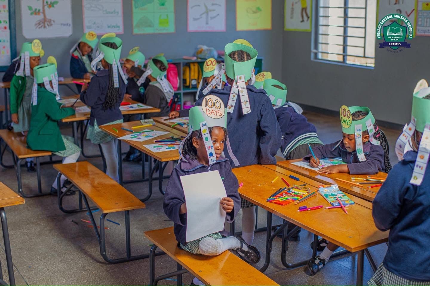 A classroom of pupils in 100 Days crowns colouring at their desks