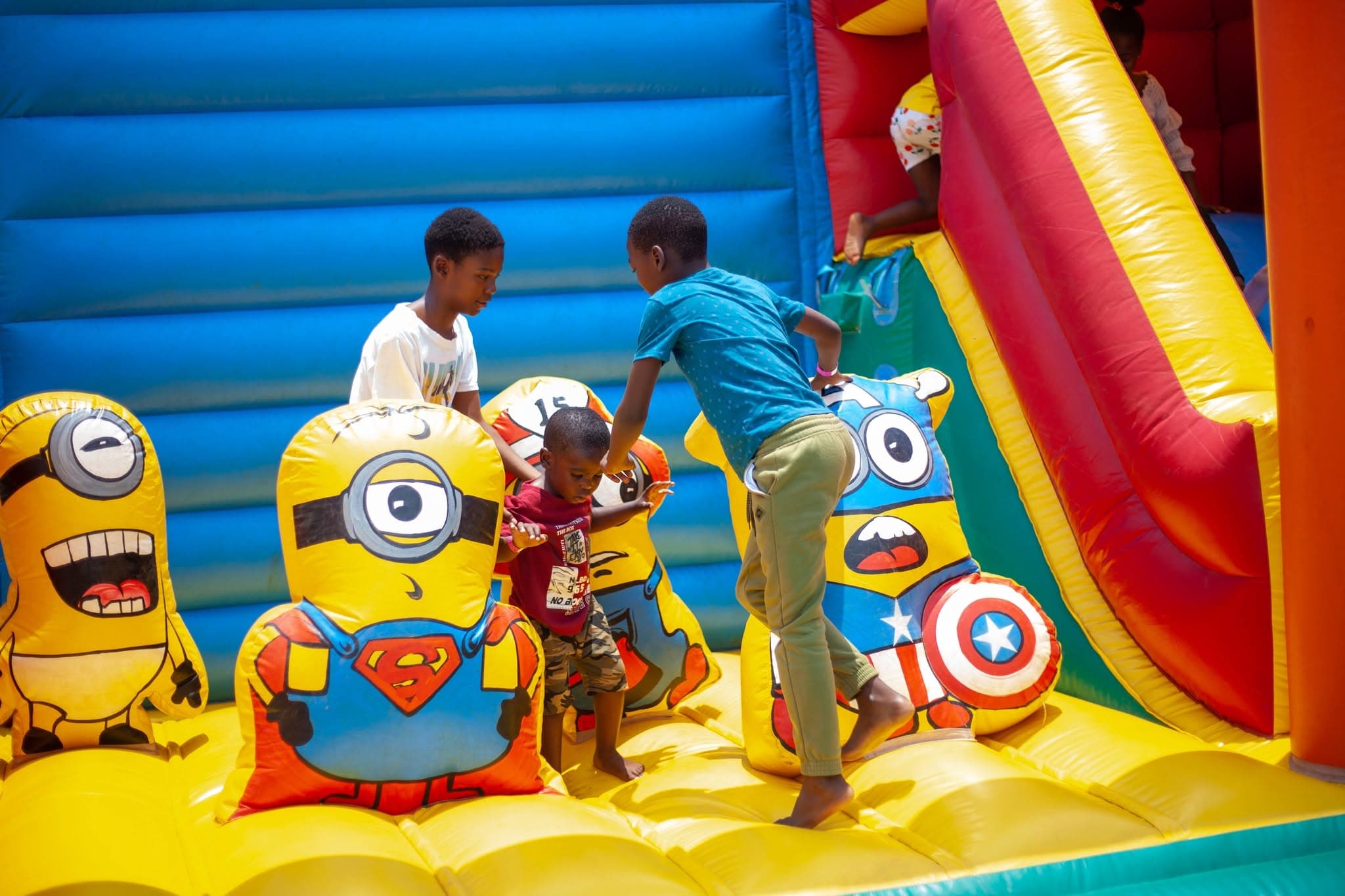 Children playing together on a colourful bouncy castle