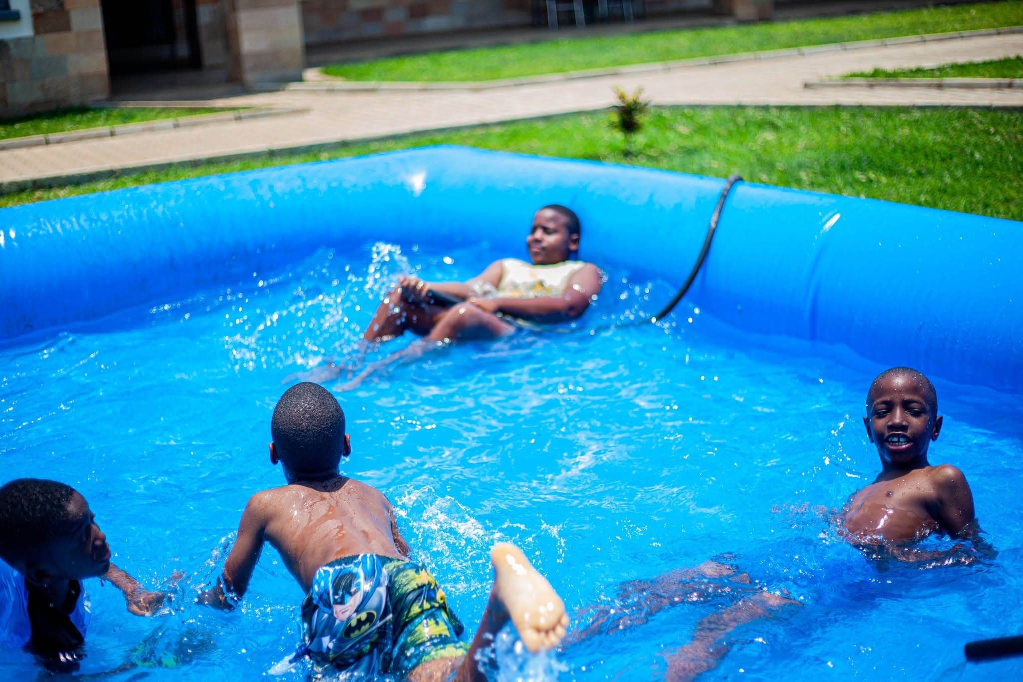 Children enjoying water play in an inflatable pool