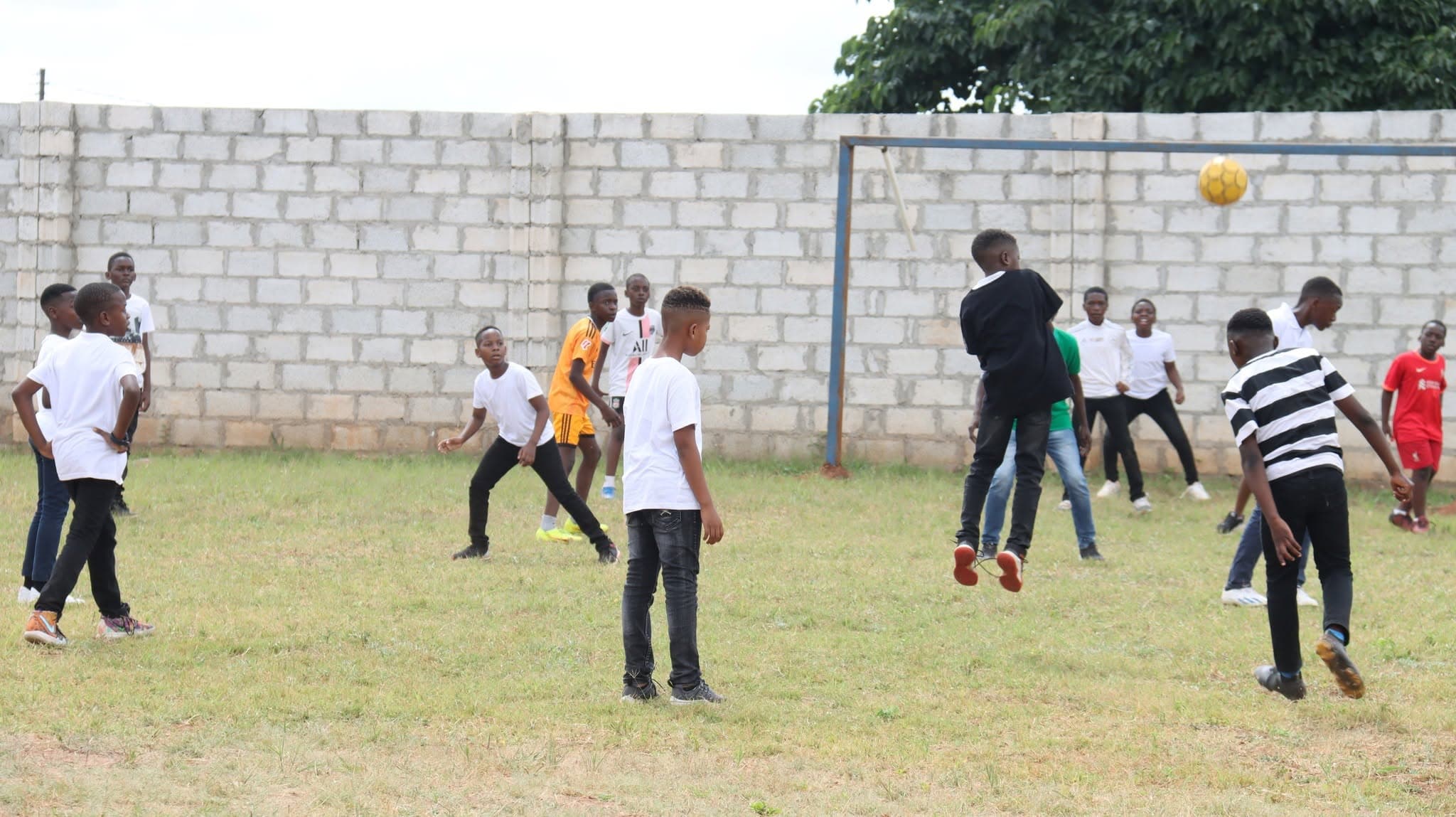 Learners following the ball during a football game
