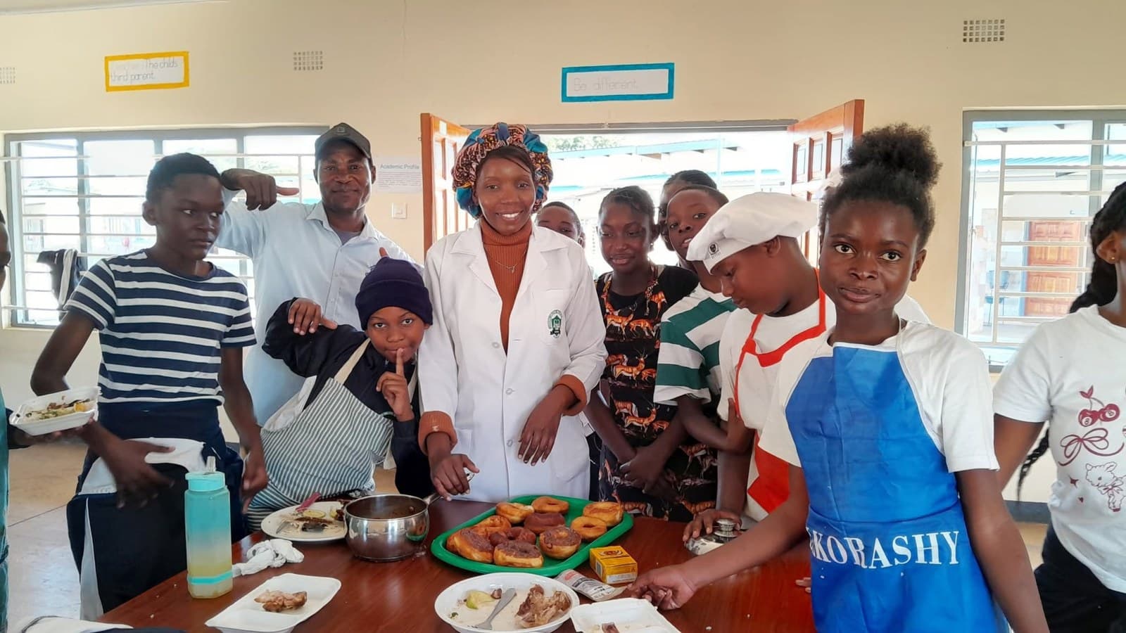 Grade 7 learners gather around a table displaying their prepared dishes